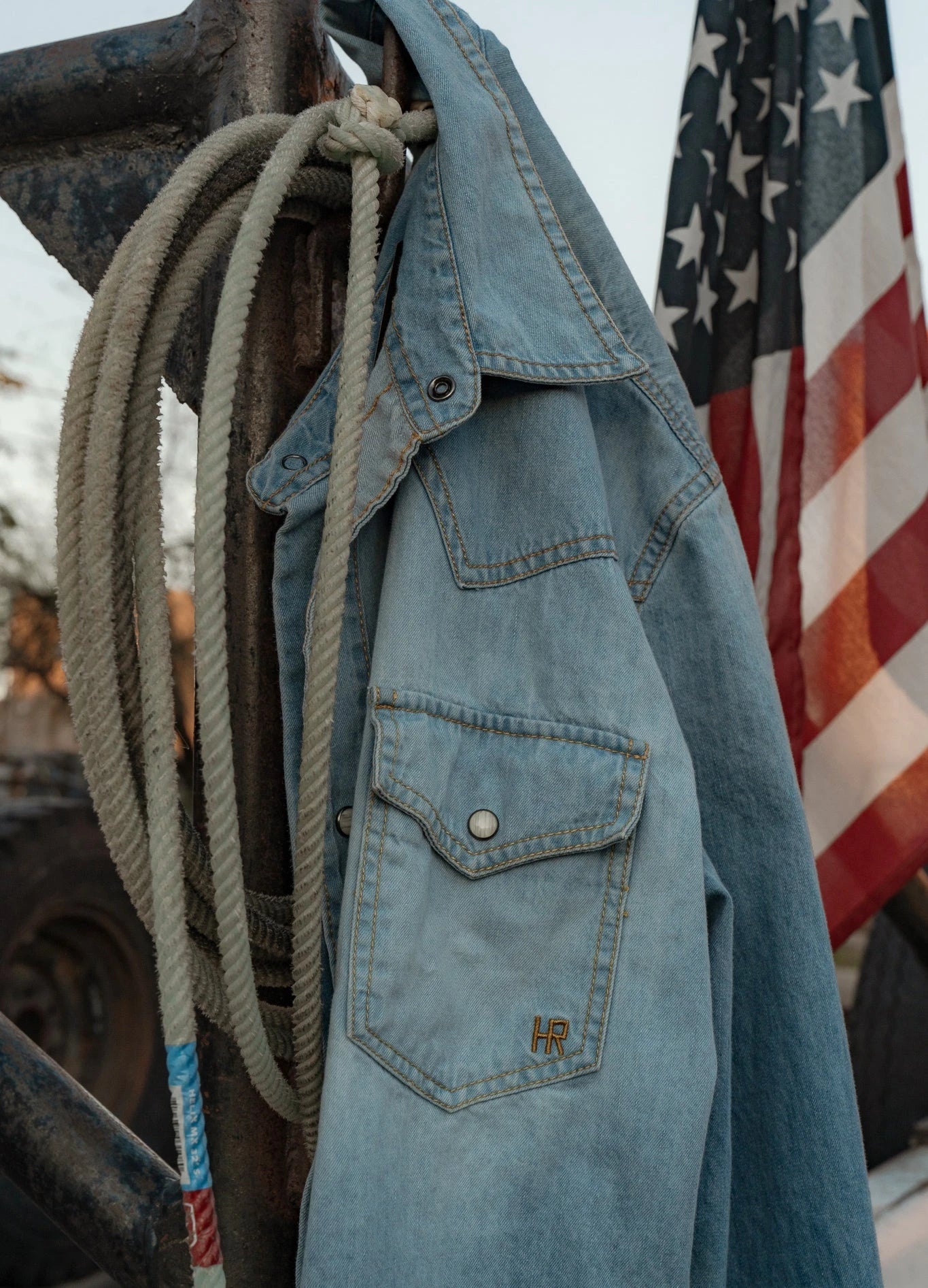HR denim shirt beside rope and an American flag