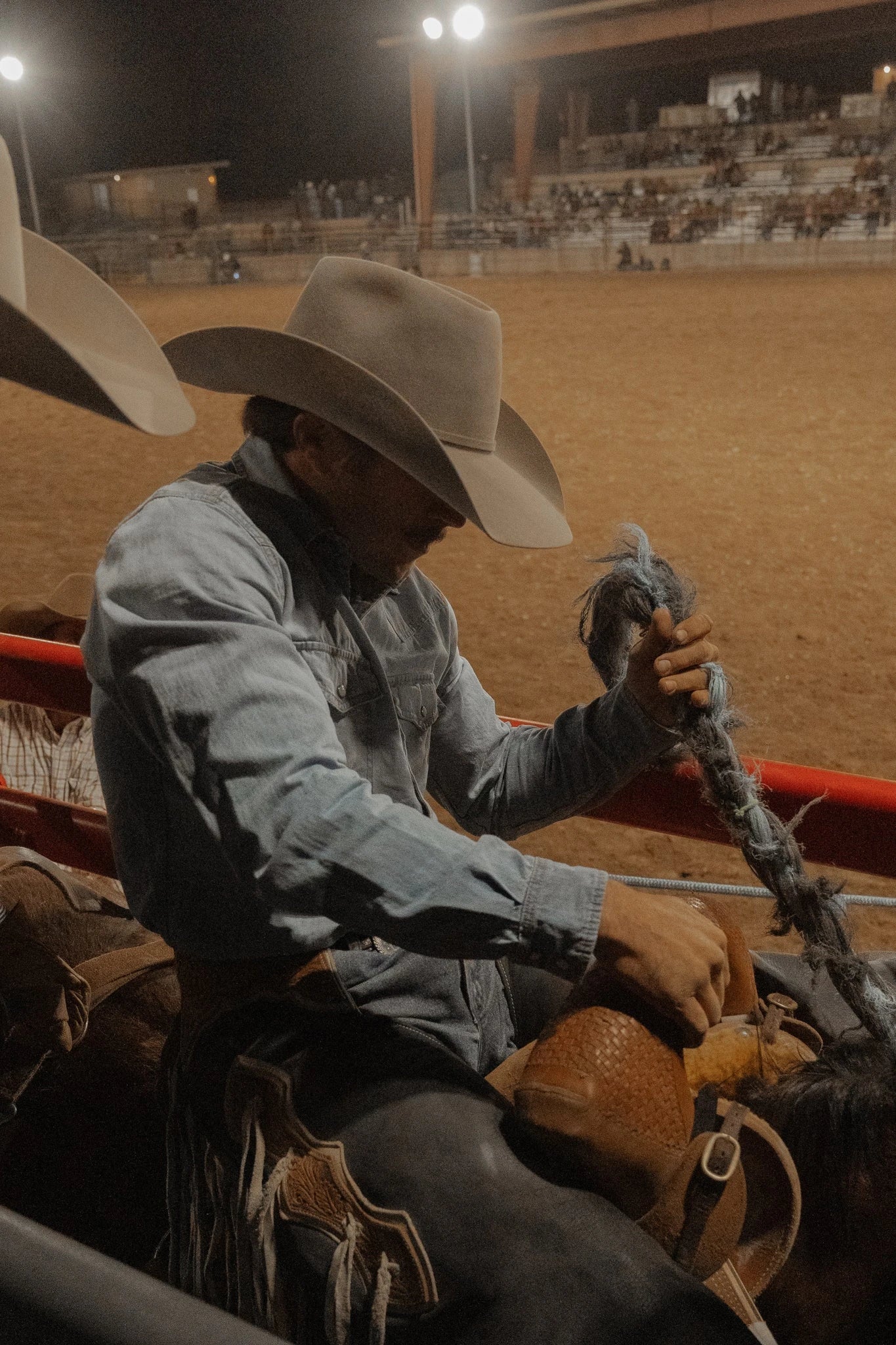 Cowboy preparing his rope at the rodeo